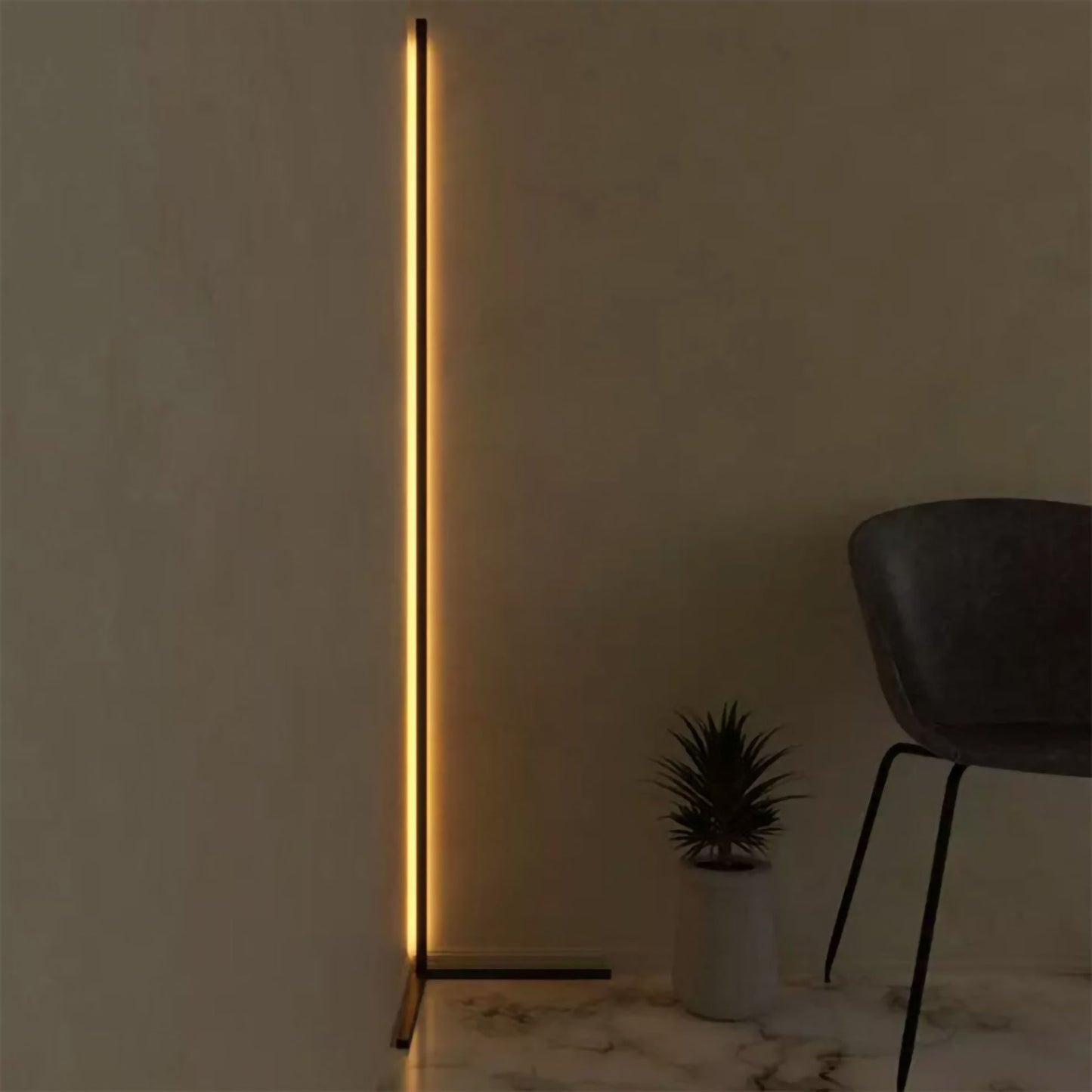 Modern floor lamp with a vertical light strip in a minimalistic room.