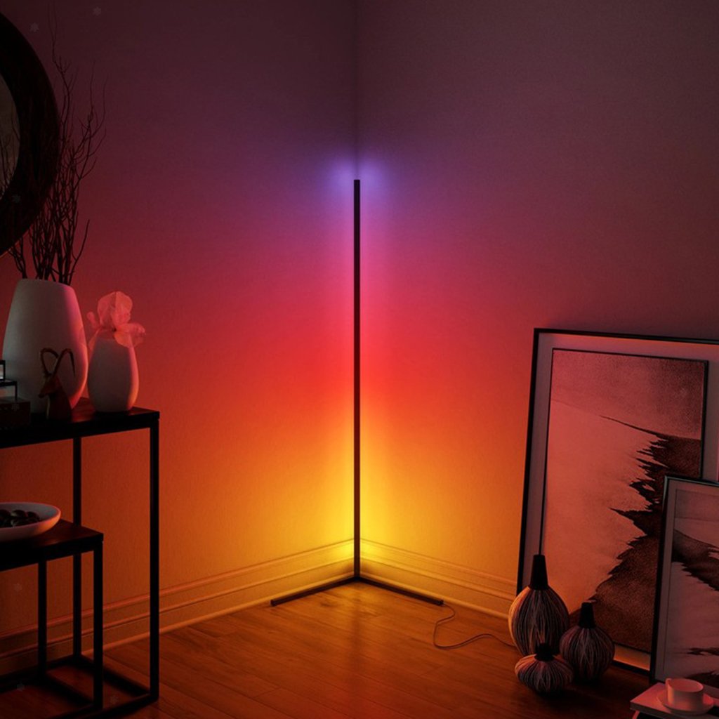 Colorful LED floor lamp casting a gradient of red to blue light in a room with decor elements.