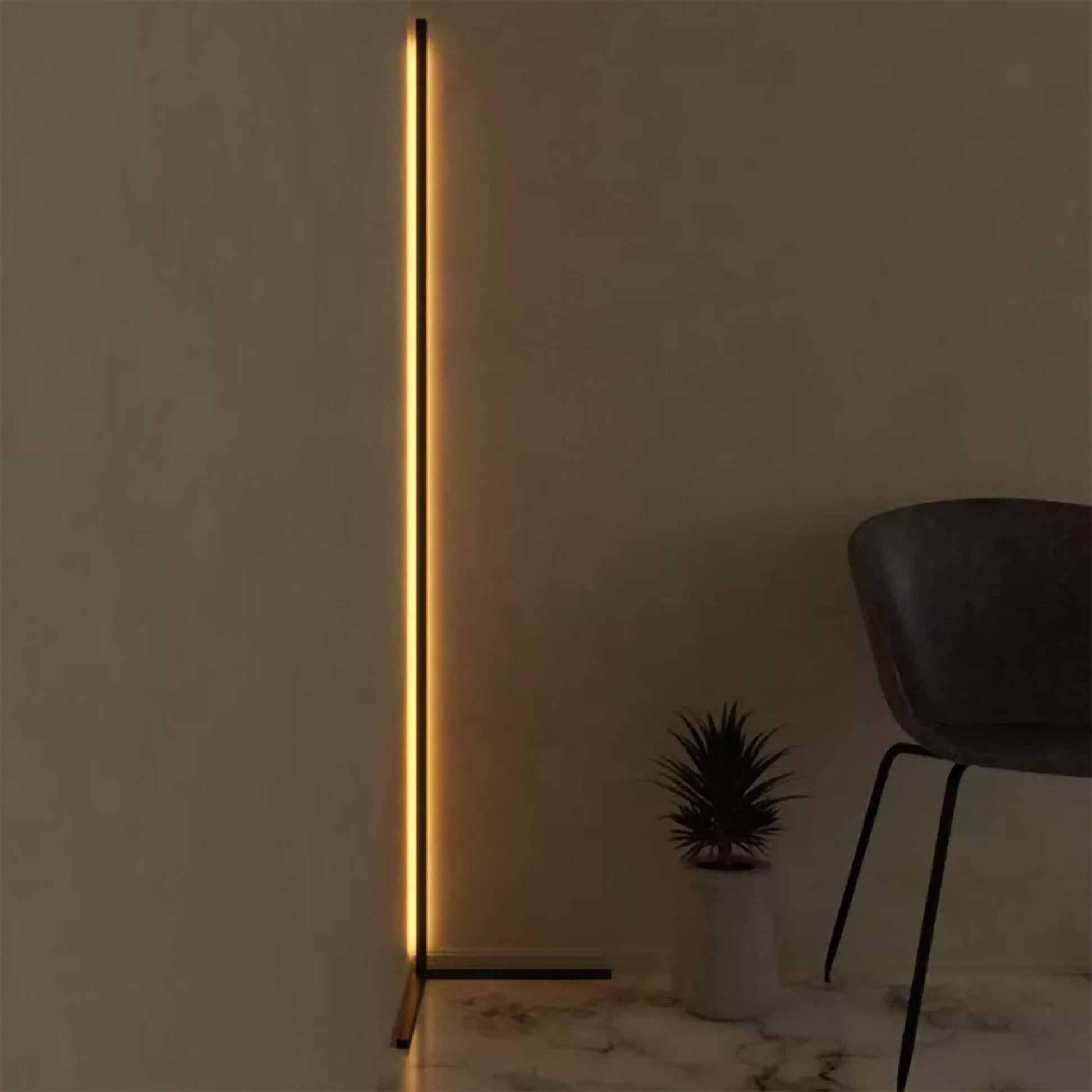 Modern floor lamp with a vertical light strip in a minimalistic room.